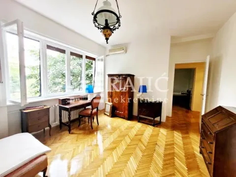 Spacious and bright room with wooden furniture and parquet flooring. - image 12