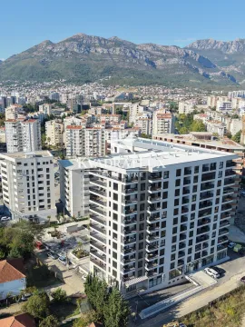 Aerial view of the residential building and the surrounding neighborhood with mountains in the background. - image 4