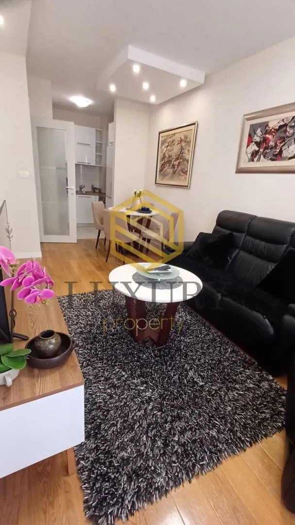 Living room with a sofa and dining table.