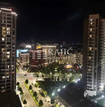 Night view from the terrace overlooking city streets and surrounding buildings. - image 8