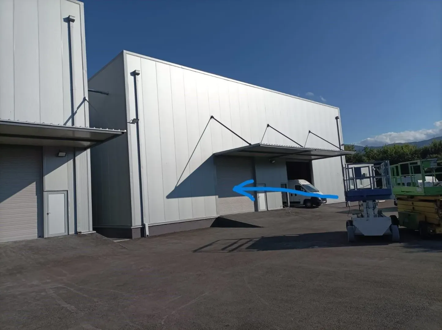 Exterior of a modern industrial facility or warehouse.