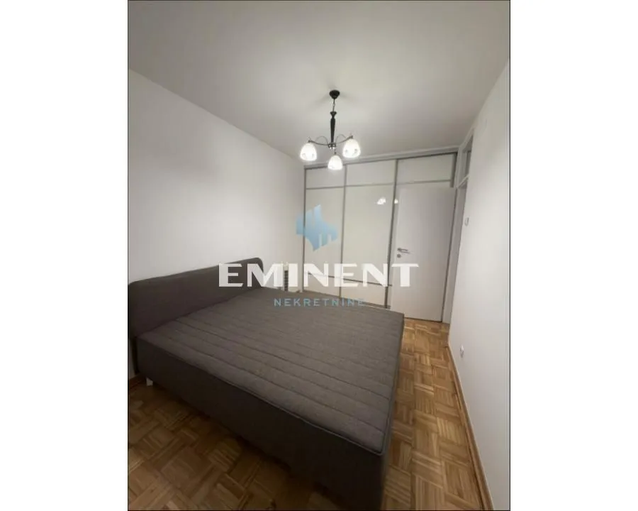 Bedroom with a double bed and a fitted wardrobe.