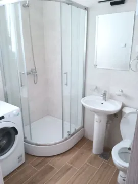 Svijetlo kupatilo sa tuš kabinom, umivaonikom, WC šoljom i veš mašinom. - image 14