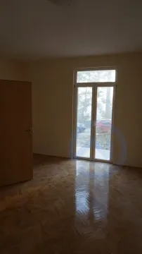 An empty room featuring polished parquet flooring and glass balcony doors. - image 19