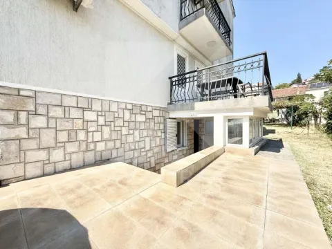 Exterior view of the house with a tiled courtyard and balcony. - image 9