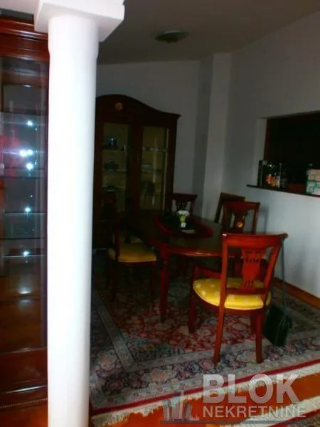 Dining area with a wooden table and chairs.