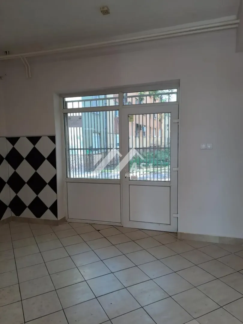 Entrance door with glass panels and ceramic tiles on the floor and wall.