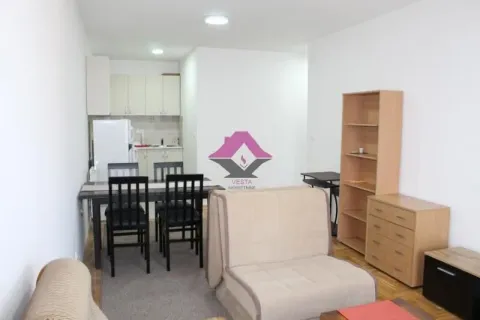 Living room with a dining area and a small kitchen in the background. - image 17