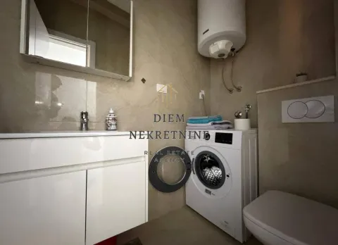 A modernly equipped bathroom with a washing machine and water heater. - image 9