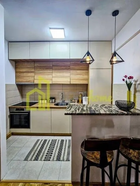 Modern kitchen with a breakfast bar and dining table.