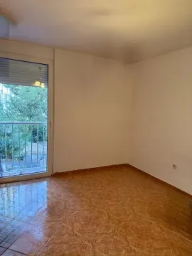 Empty room with tiled flooring and a balcony door. - image 6