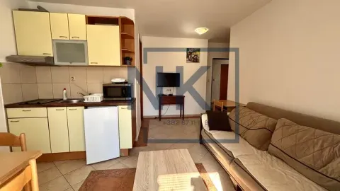 Living room with a sofa and an integrated kitchen. - image 5