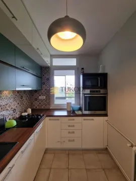 Small kitchen with built-in cabinetry and a window. - image 9