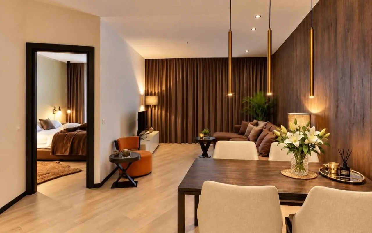 Living room with a dining area and a view of the bedroom.