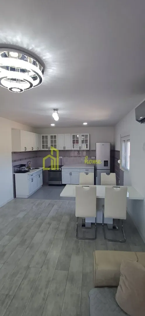 Kitchen with dining area and white cabinetry.