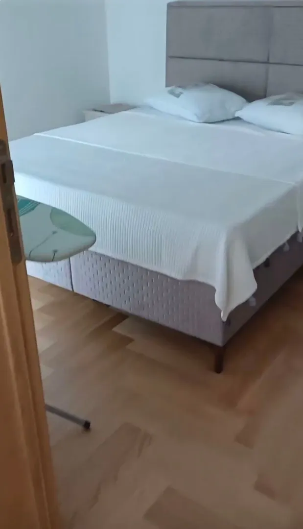 Bedroom with a double bed and wooden flooring.