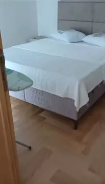 Bedroom with a double bed and wooden flooring. - image 7