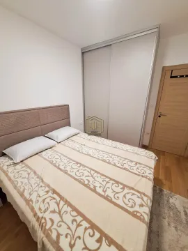 Furnished bedroom with a double bed, built-in wardrobe, and wooden flooring. - image 8