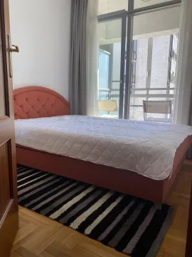 A bright bedroom with a bed and access to the balcony. - image 6