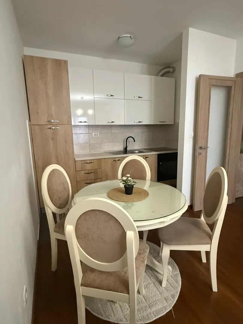 Bright kitchen with a dining table and four chairs.