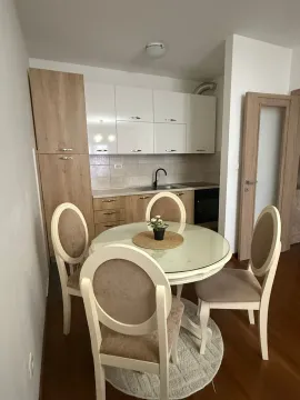 Bright kitchen with a dining table and four chairs. - image 5