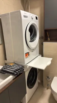 Bathroom with washing machine and dryer. - image 11
