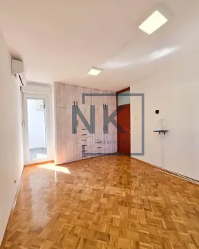 Empty bedroom with a built-in wardrobe and parquet flooring. - image 4