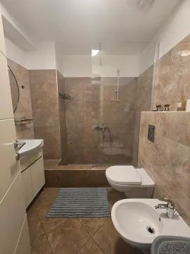Savremeno opremljeno kupatilo sa tuš kabinom i sanitarijama u bež tonovima. - image 7