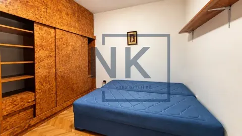 Bedroom with a wardrobe and a bed. - image 3