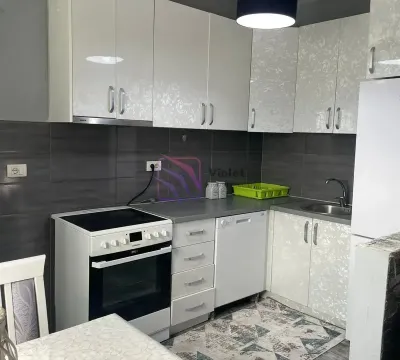 Kitchen with white cabinetry, stove, and sink. - image 7