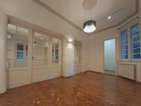 Empty living room with parquet flooring and white wooden doors. - image 3