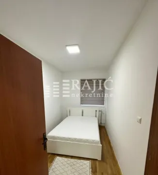 Smaller bedroom with a double bed and parquet flooring. - image 8