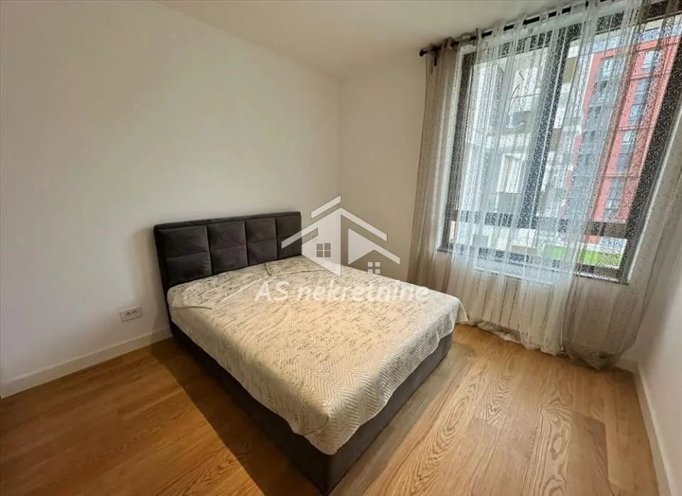 Bedroom with a double bed and a window.