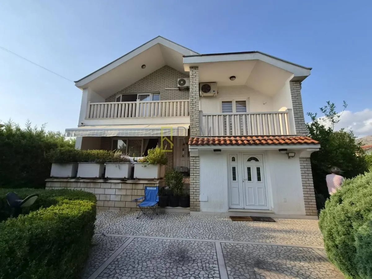 View of a two-story house with a landscaped yard.