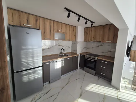 Modern kitchen with wooden cabinets, grey fronts, and built-in appliances. - image 3