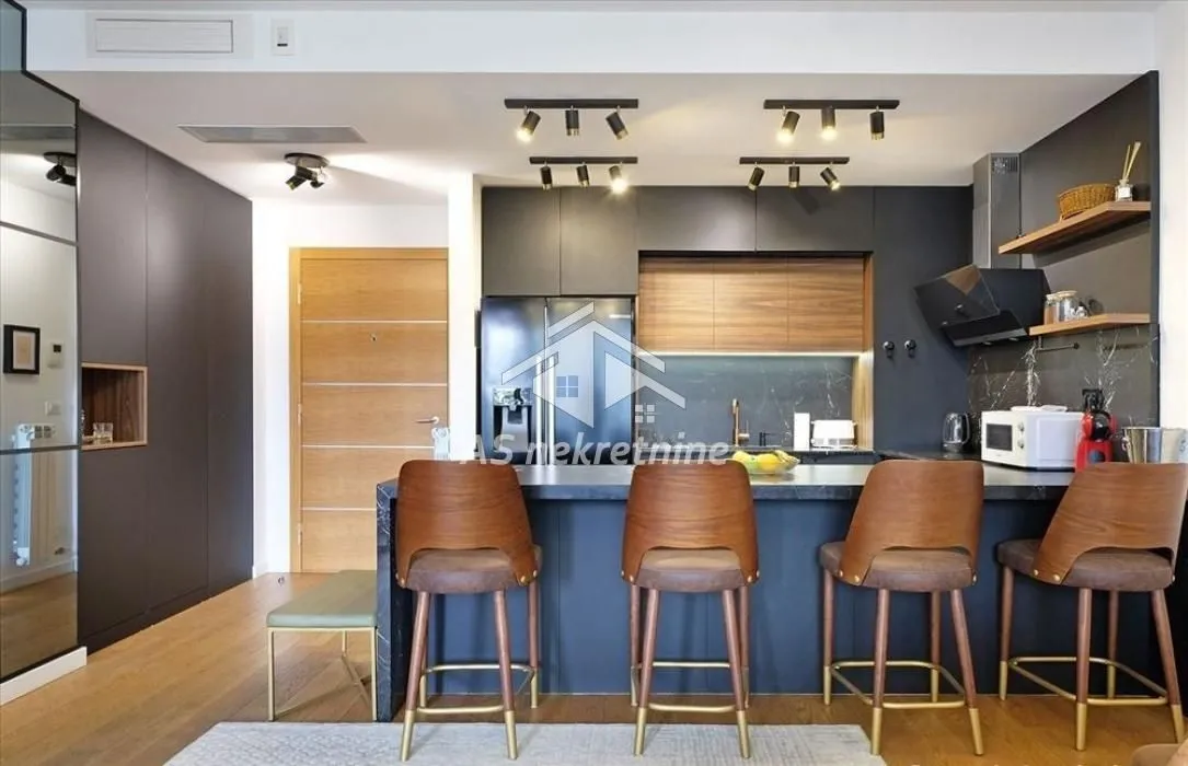 Modern kitchen with a breakfast bar and wooden bar stools.