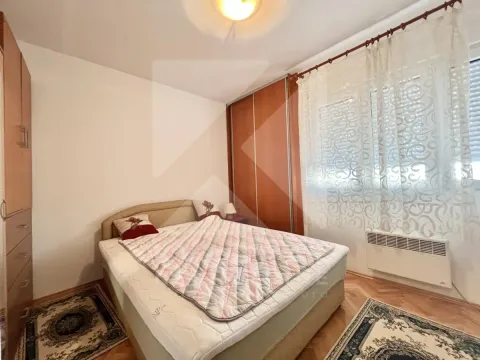Furnished bedroom with a double bed, wardrobe, and a window. - image 7