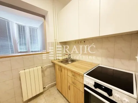 Small kitchen with white cabinets and a stove. - image 4