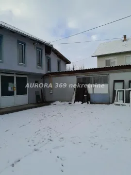 View of the courtyard and the facade of the house covered in snow. - image 2