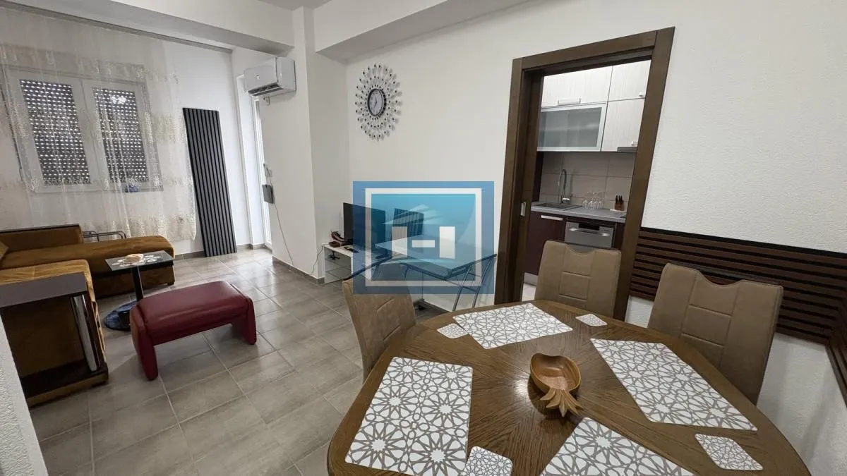 Living room with dining area and view of the kitchen.