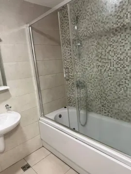 Bathroom equipped with a shower cabin, bathtub, and washbasin. - image 5