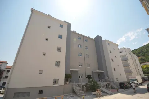 View of the exterior of the residential building with the entrance and stairs. - image 13