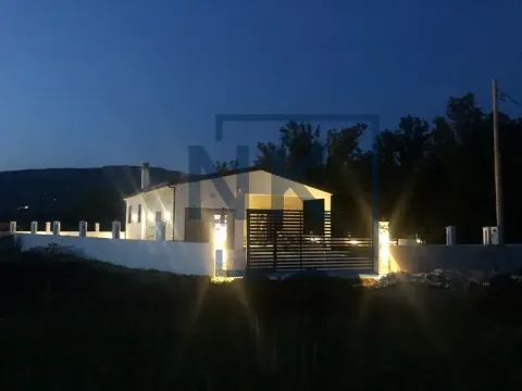 View of the illuminated house and yard at night. - image 2
