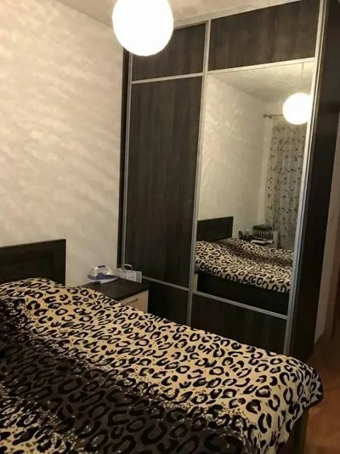 Bedroom with a double bed and a large fitted wardrobe with a mirror.
