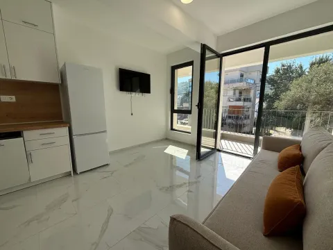 Living room with a kitchen and access to the terrace. - image 6