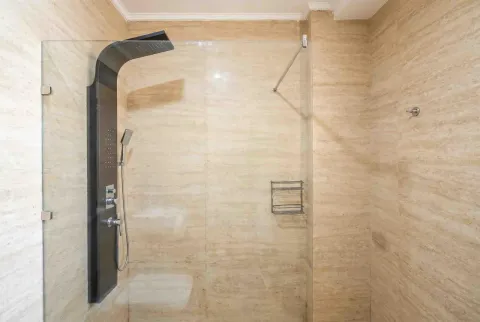 Modern shower cabin with marble tiles in the bathroom. - image 6