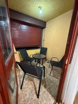 Small covered terrace with a table and four chairs. - image 17