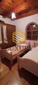 Bedroom with two wooden beds and a wardrobe. - image 6