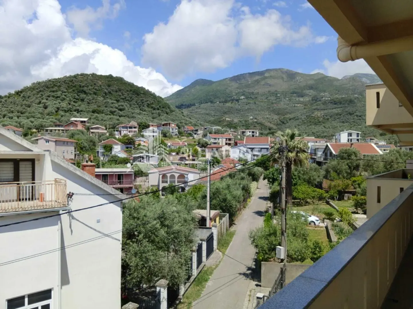 View from the terrace towards the surrounding settlement and hills.