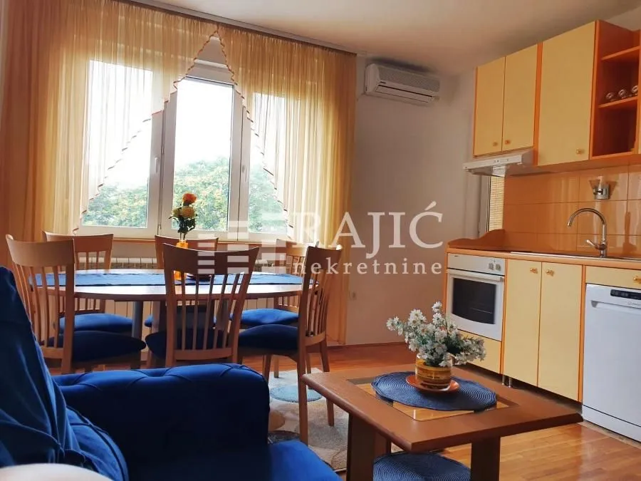 Living room with dining area and kitchen.